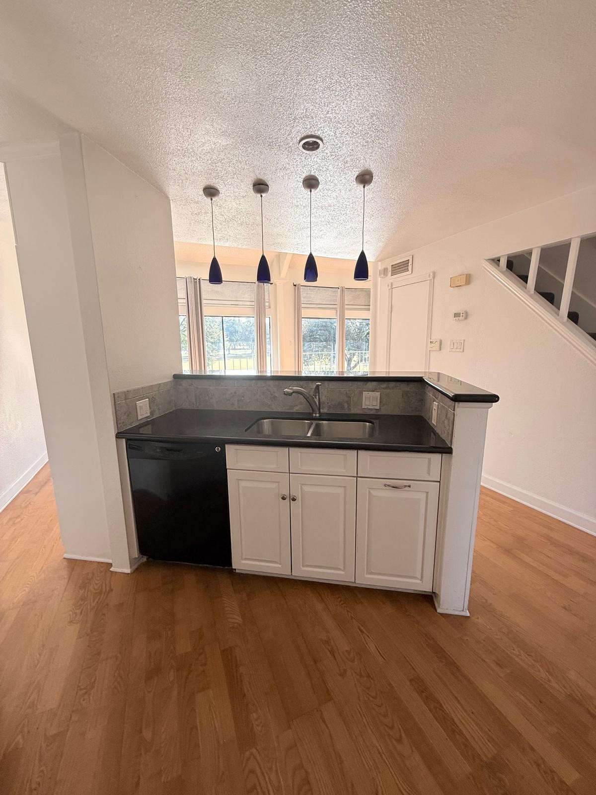 8287 Sands Point Drive, Unit 128 Houston, TX 77036 - Photo 10 of 30 a kitchen with granite countertop a sink and a stove