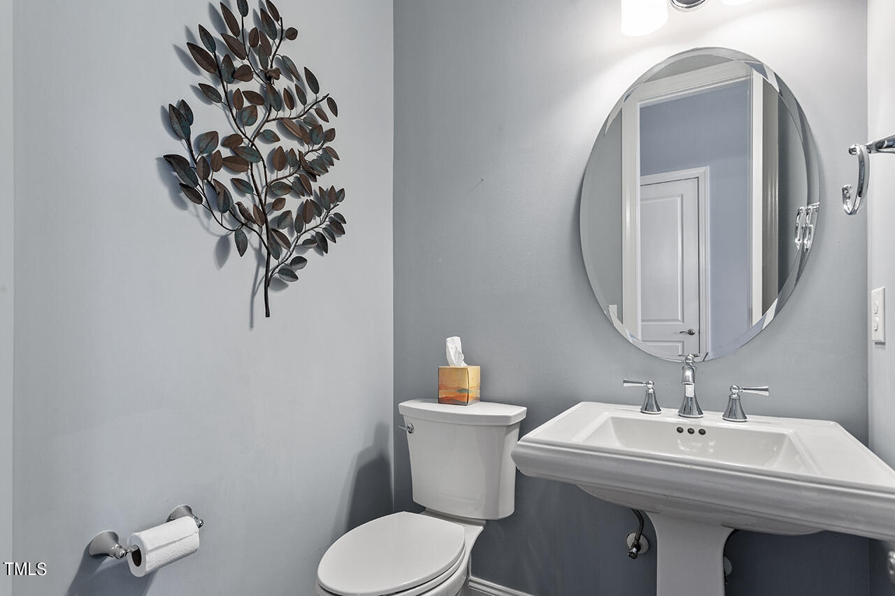 5273 Aleppo Lane Raleigh, NC 27613 - Photo 13 of 56 a bathroom with a toilet sink and mirror