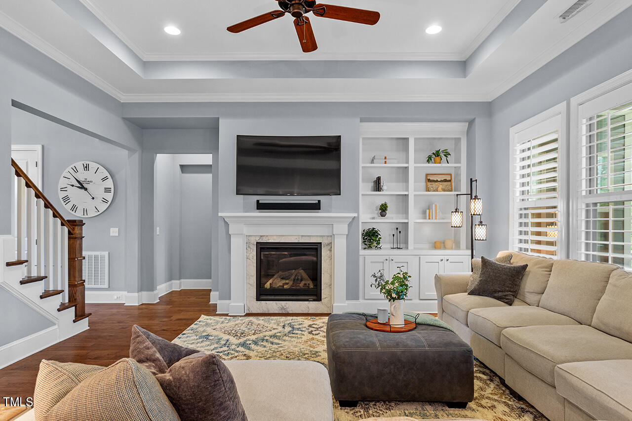 5273 Aleppo Lane Raleigh, NC 27613 - Photo 16 of 56 a living room with furniture a flat screen tv and a fireplace
