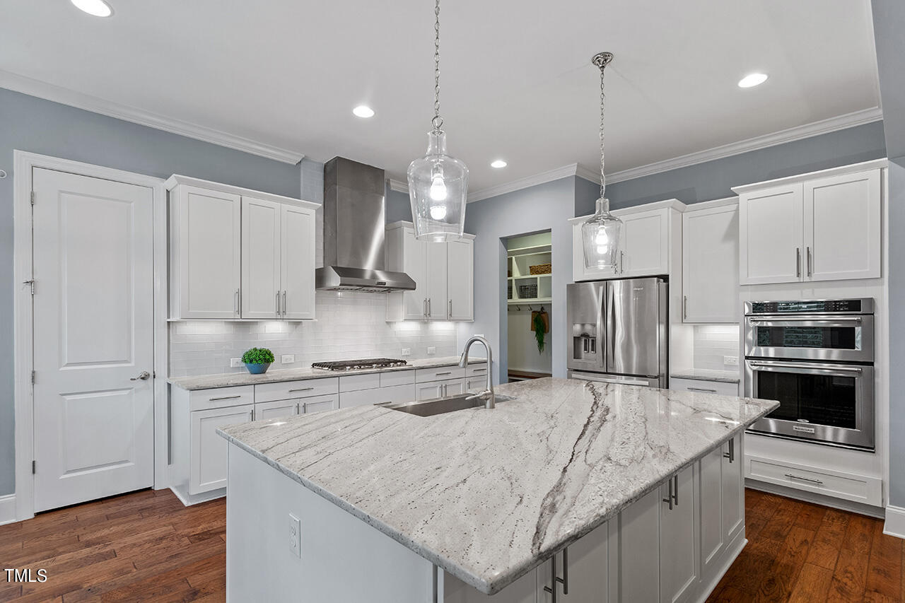 5273 Aleppo Lane Raleigh, NC 27613 - Photo 23 of 56 a kitchen with stainless steel appliances granite countertop a sink refrigerator and cabinets