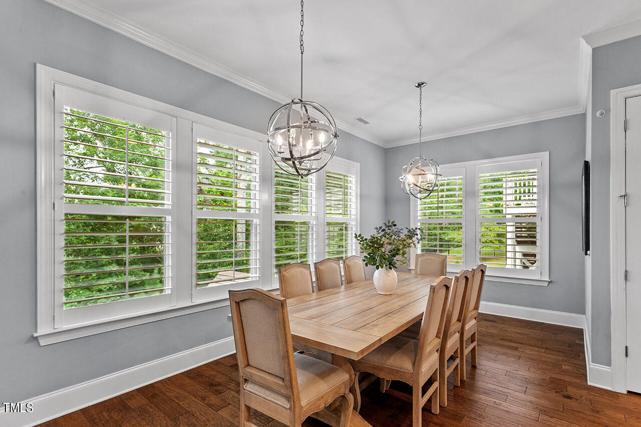 5273 Aleppo Lane Raleigh, NC 27613 - Photo 24 of 56 a view of a dining room with furniture window and wooden floor