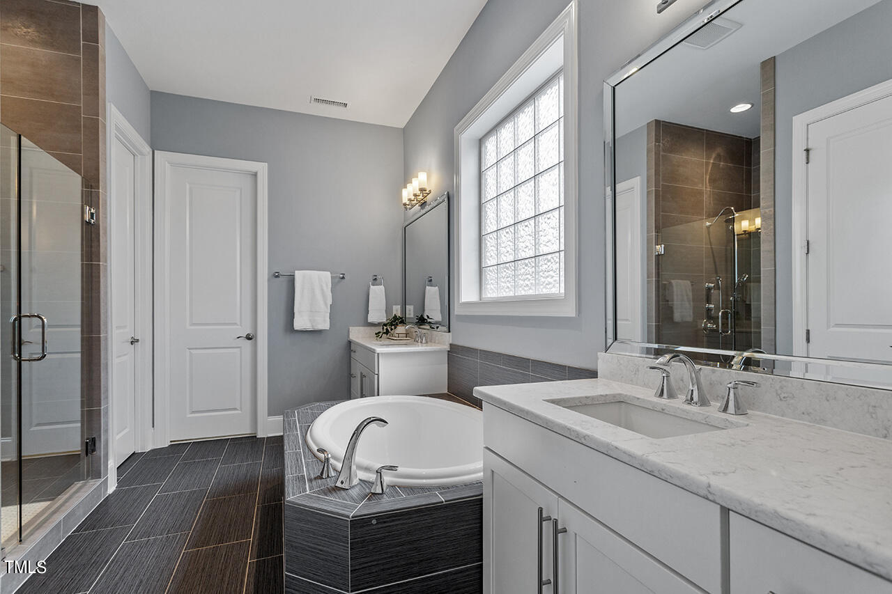 5273 Aleppo Lane Raleigh, NC 27613 - Photo 31 of 56 a bathroom with a granite countertop sink toilet and shower