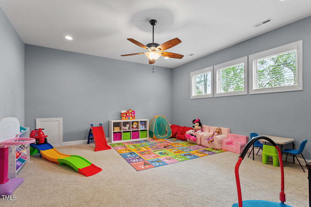 5273 Aleppo Lane Raleigh, NC 27613 - Photo 34 of 56 a bedroom with a bed and a chandelier
