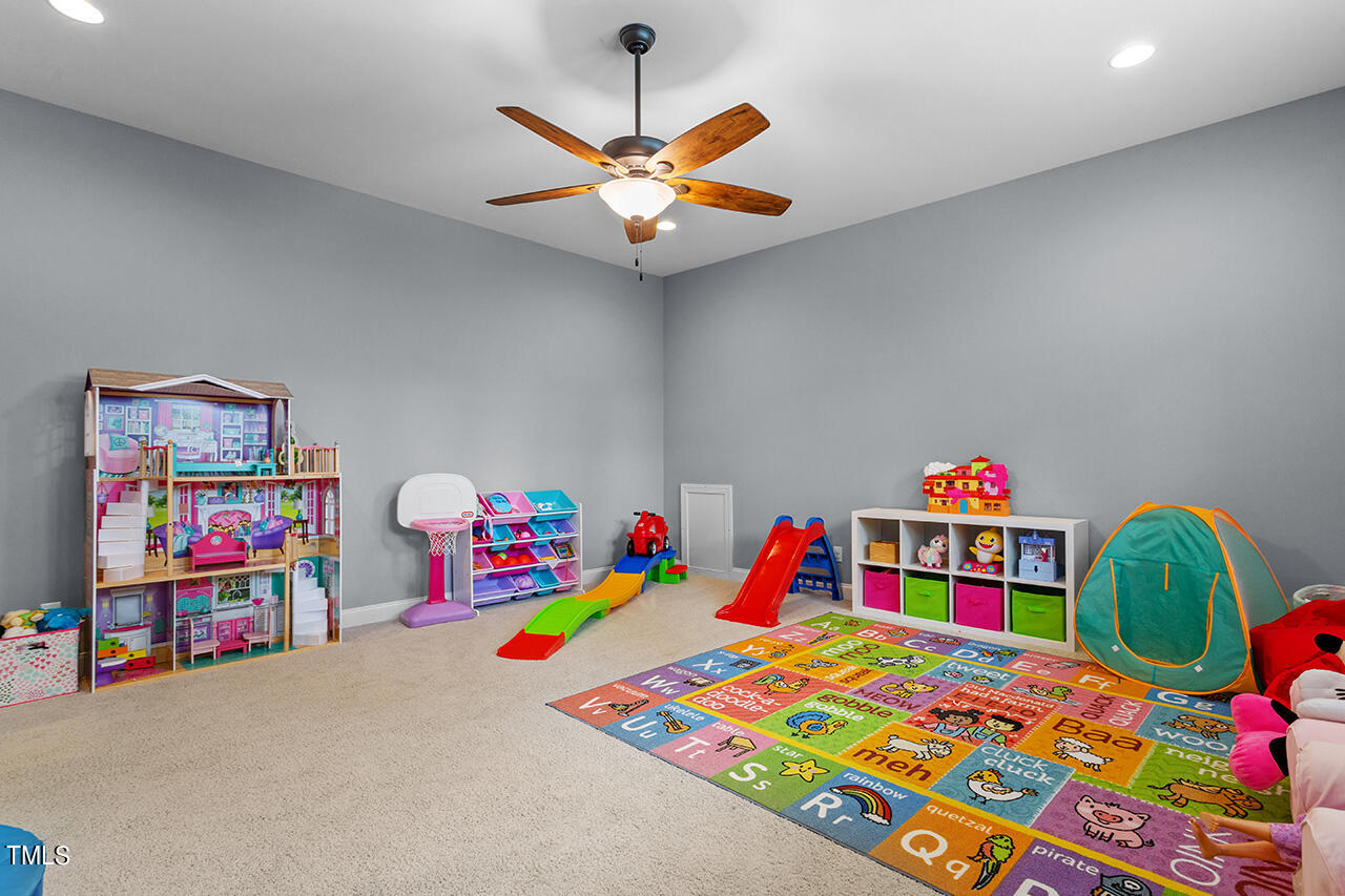5273 Aleppo Lane Raleigh, NC 27613 - Photo 35 of 56 a bedroom with a bed and a book shelf