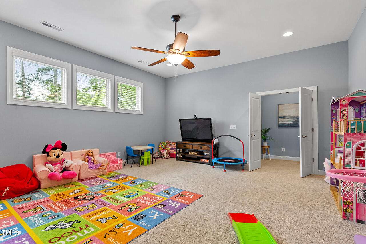 5273 Aleppo Lane Raleigh, NC 27613 - Photo 36 of 56 a bedroom with a bed and a chandelier