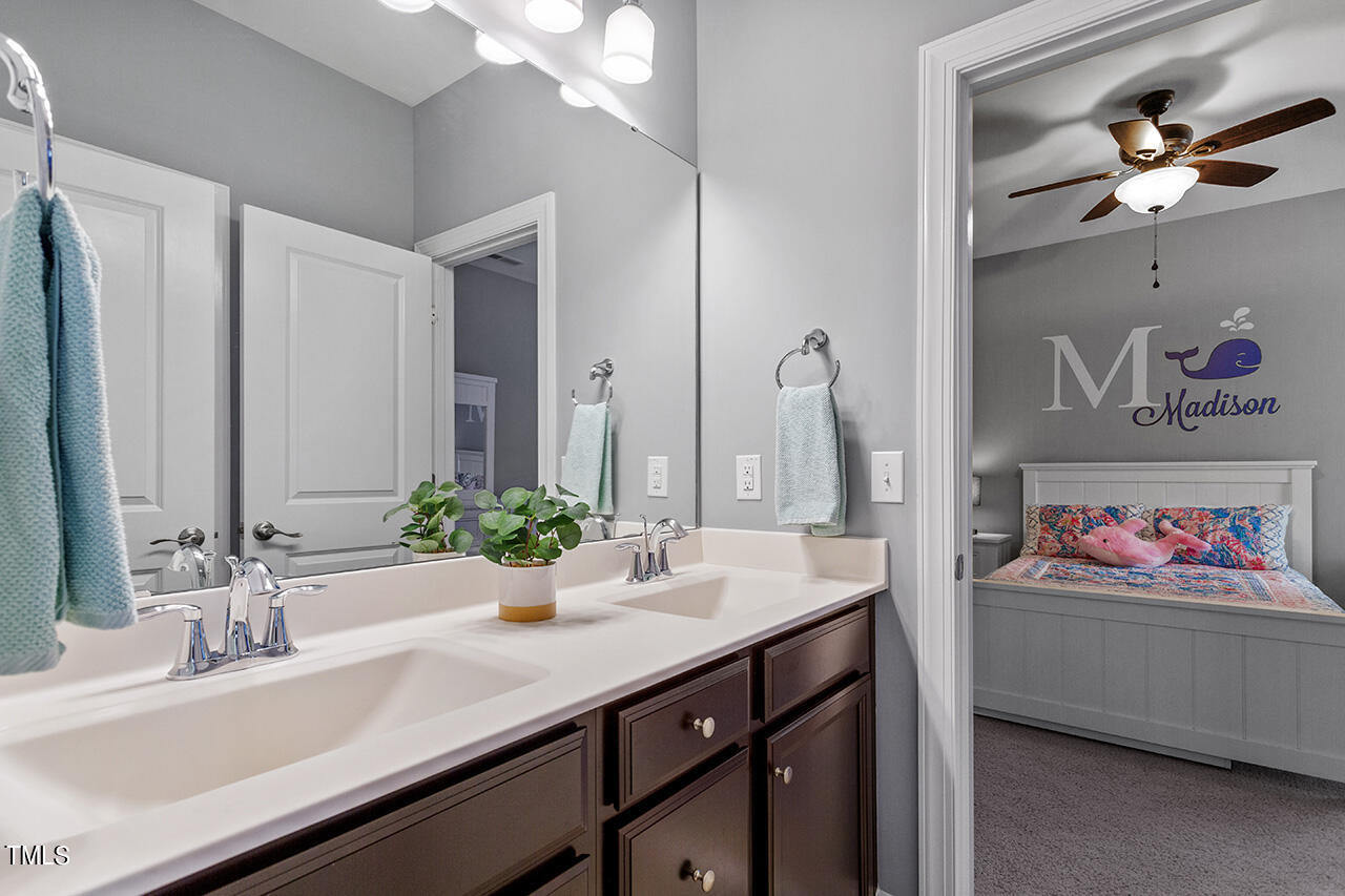 5273 Aleppo Lane Raleigh, NC 27613 - Photo 38 of 56 a bathroom with a double vanity sink and a mirror
