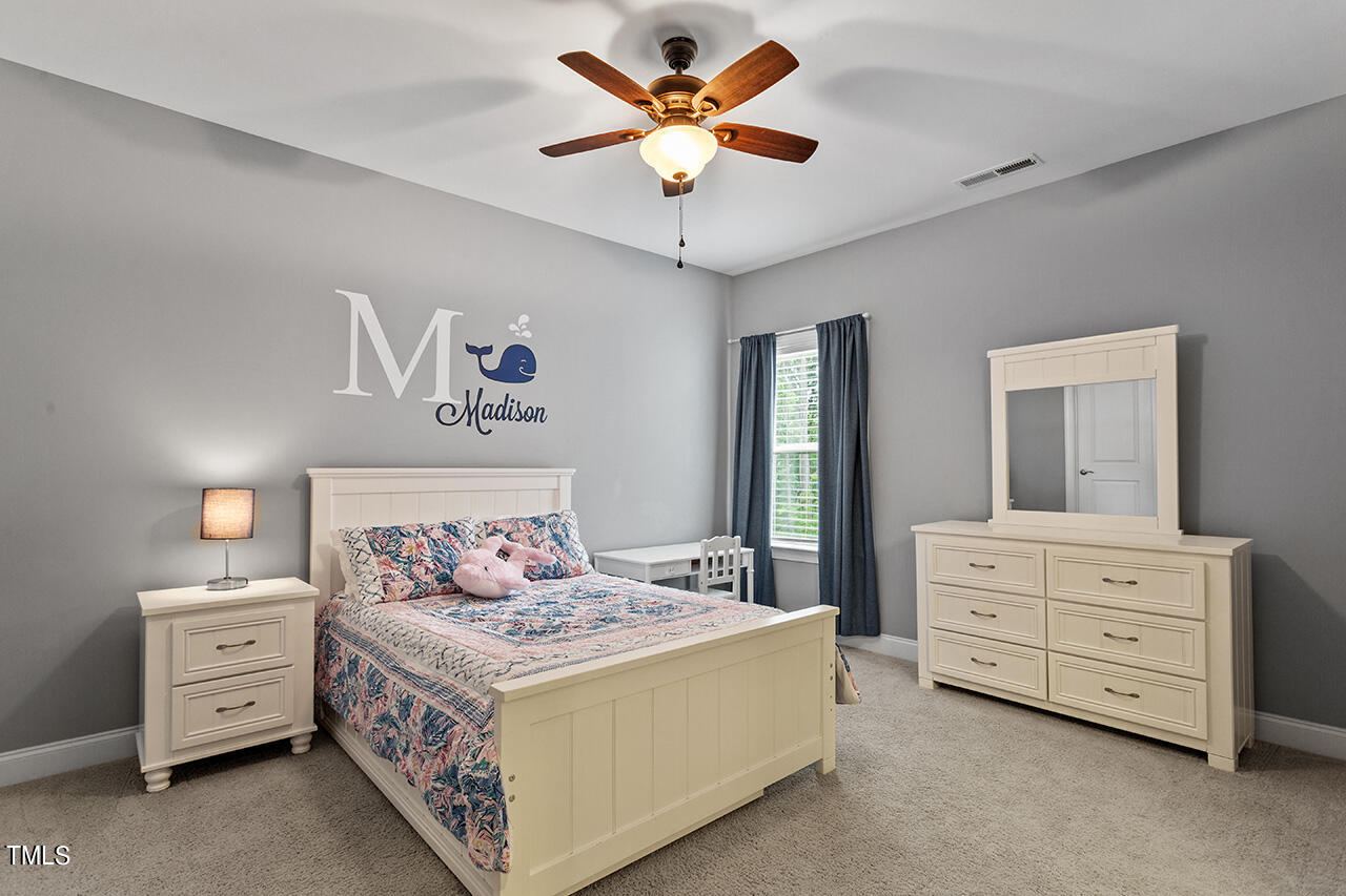 5273 Aleppo Lane Raleigh, NC 27613 - Photo 39 of 56 a bed room with a bed and a chandelier