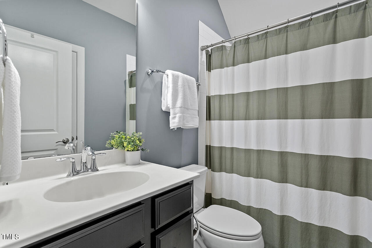 5273 Aleppo Lane Raleigh, NC 27613 - Photo 40 of 56 a bathroom with a sink toilet and shower