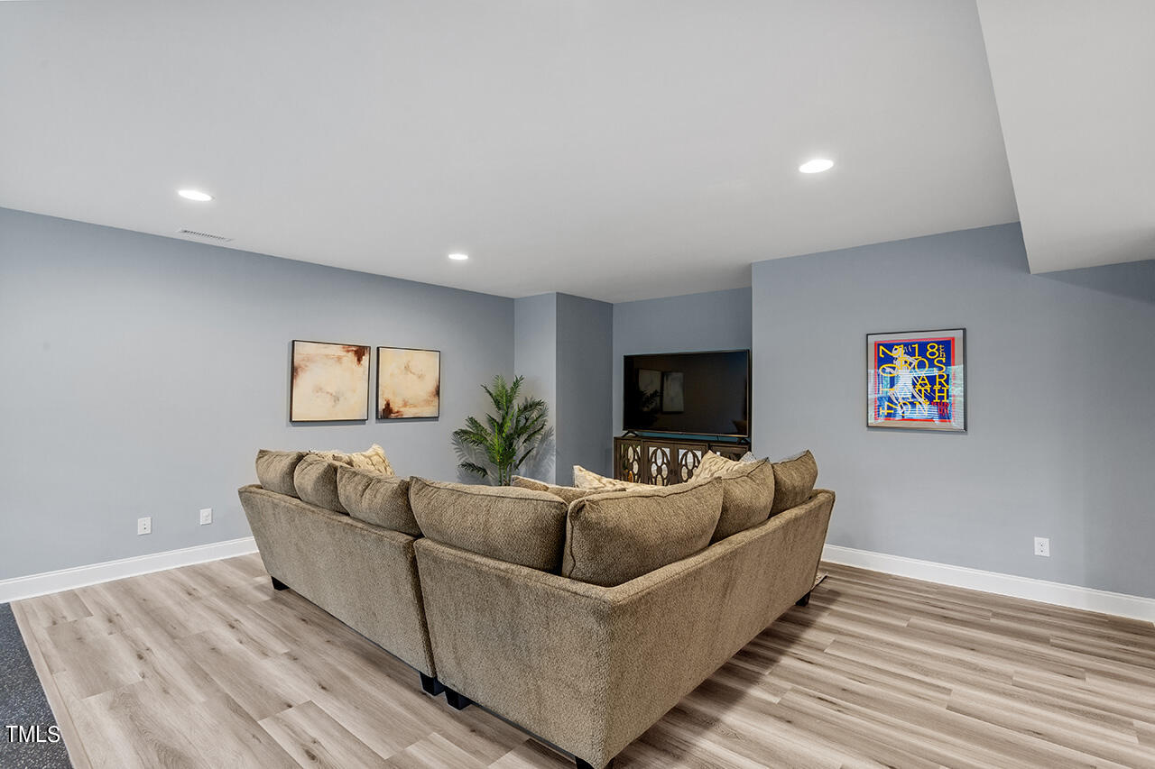5273 Aleppo Lane Raleigh, NC 27613 - Photo 45 of 56 a living room with furniture and a flat screen tv