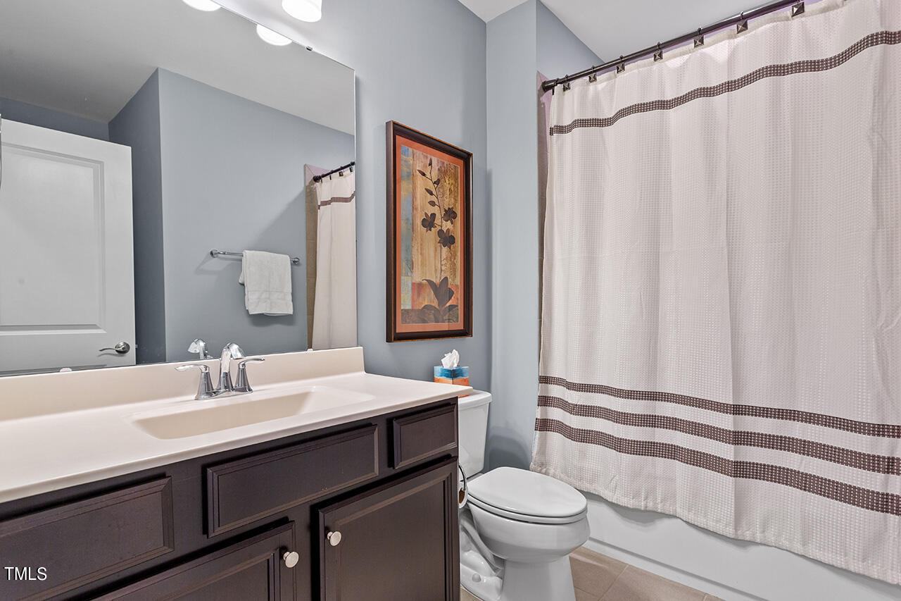 5273 Aleppo Lane Raleigh, NC 27613 - Photo 50 of 56 a bathroom with a sink a toilet and a mirror