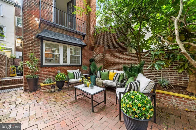 a backyard of a house with outdoor seating