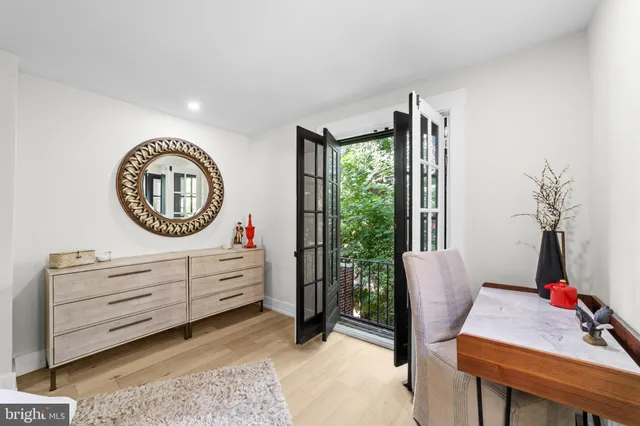 a living room with furniture a mirror and a window