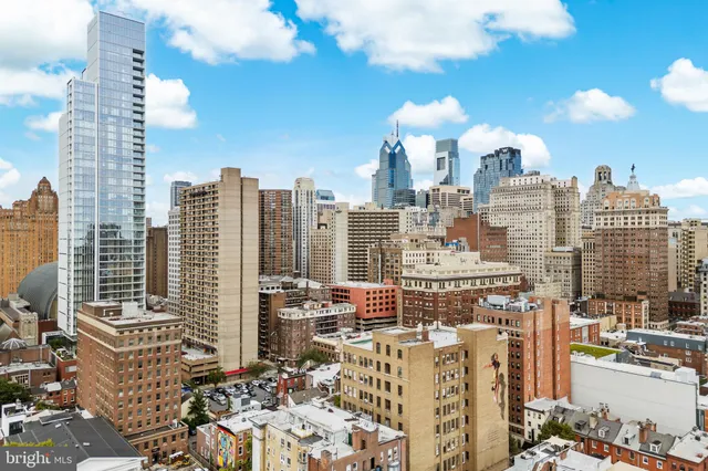 an aerial view of residential building with green space