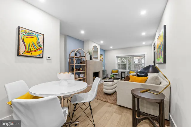 a living room with furniture a rug and a wall painting