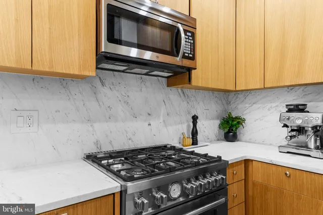 a kitchen with a stove a microwave and cabinets
