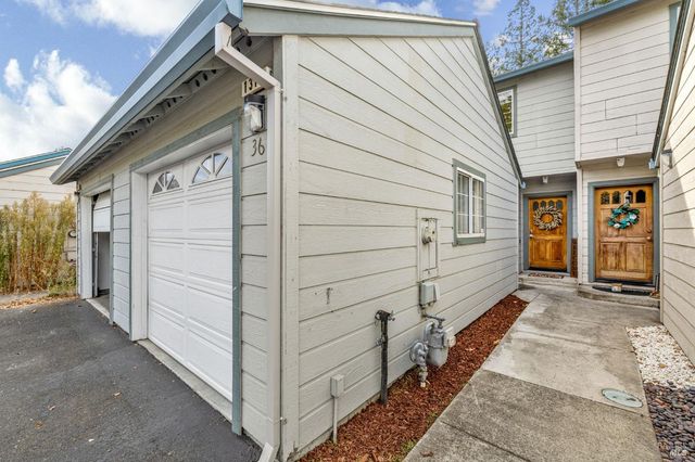 a view of a house with a door and wooden walls