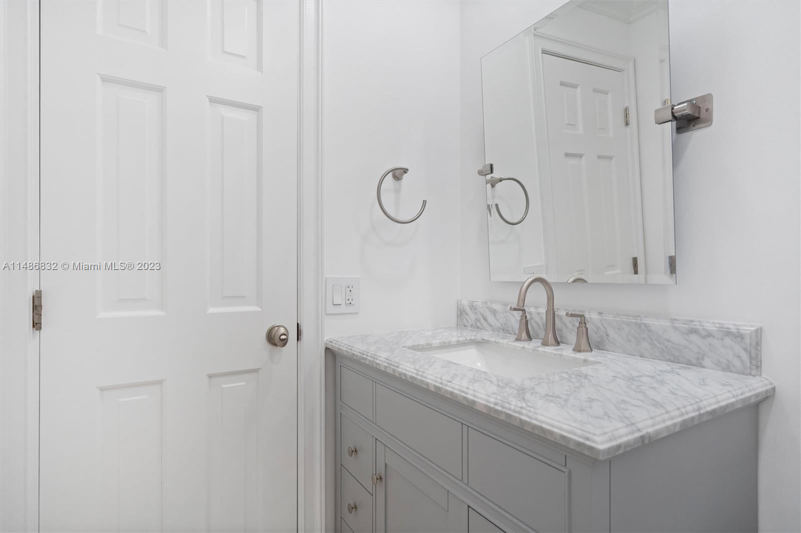 4160 Bay Point Road Miami, FL 33137 - Photo 8 of 27 a bathroom with a granite countertop sink and a mirror