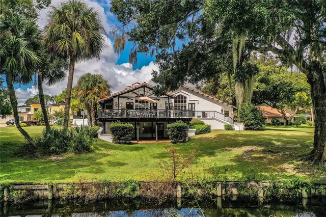 a view of a house with yard and sitting area