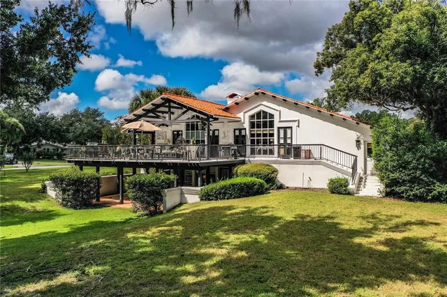 a car parked in the grass near a house