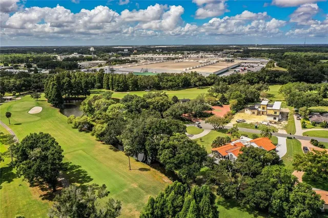 a living room with fireplace furniture and a large window