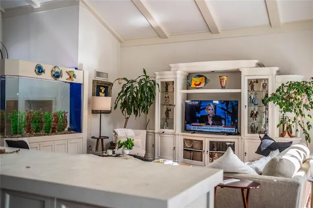 a living room with furniture large window and flat screen tv