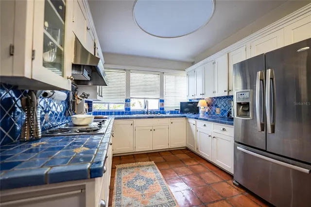 a kitchen with stainless steel appliances granite countertop a stove and cabinets