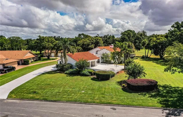 an aerial view of a house with yard swimming pool and outdoor seating