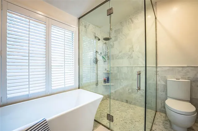 a bedroom with a bed a dresser and a window