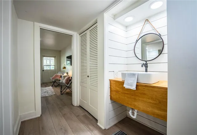 a view of a patio with table and chairs under an umbrella with a barbeque