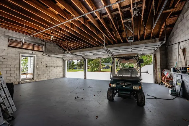 a view of a patio with couches chairs and wooden floor
