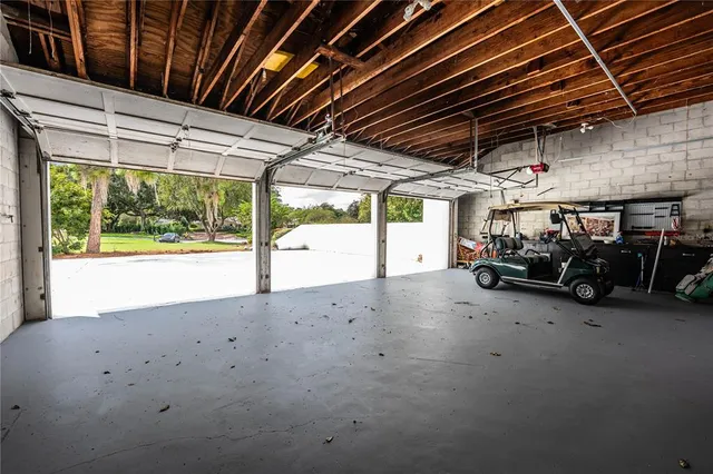 a front view of a house with a yard and potted plants