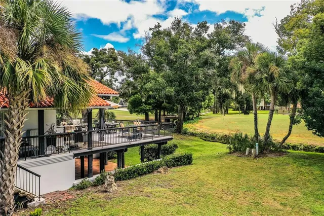 a front view of house with yard and trees in the background