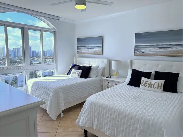 a bedroom with two beds and two windows