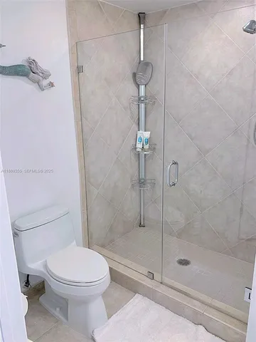 a bathroom with a shower and a toilet