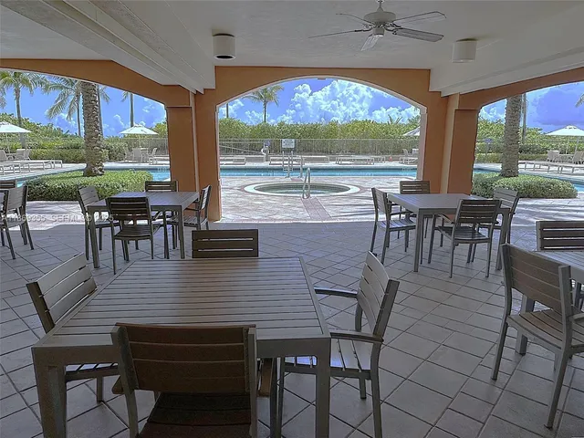 a view of a dining room with furniture large windows and wooden floor