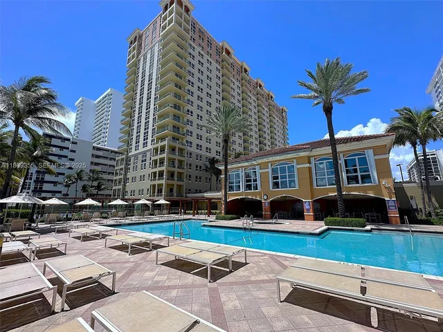 a view of a palm trees and a building in the background