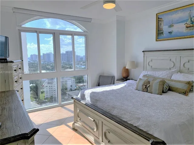 a bedroom with a large bed and a window