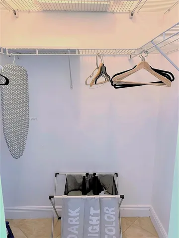 a view of a room with rack on the wall and a window