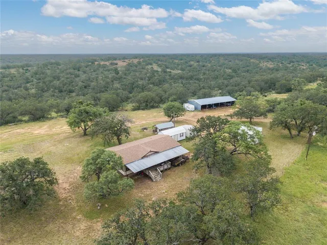 a living room with furniture a flat screen tv and a window
