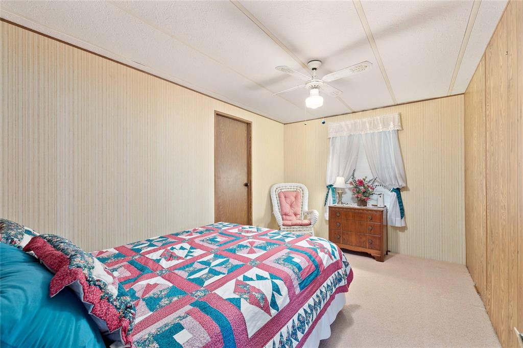 11814 County Road 266 Rochelle, TX 76872 - Photo 26 of 40 a bedroom with a bed and a bookshelf