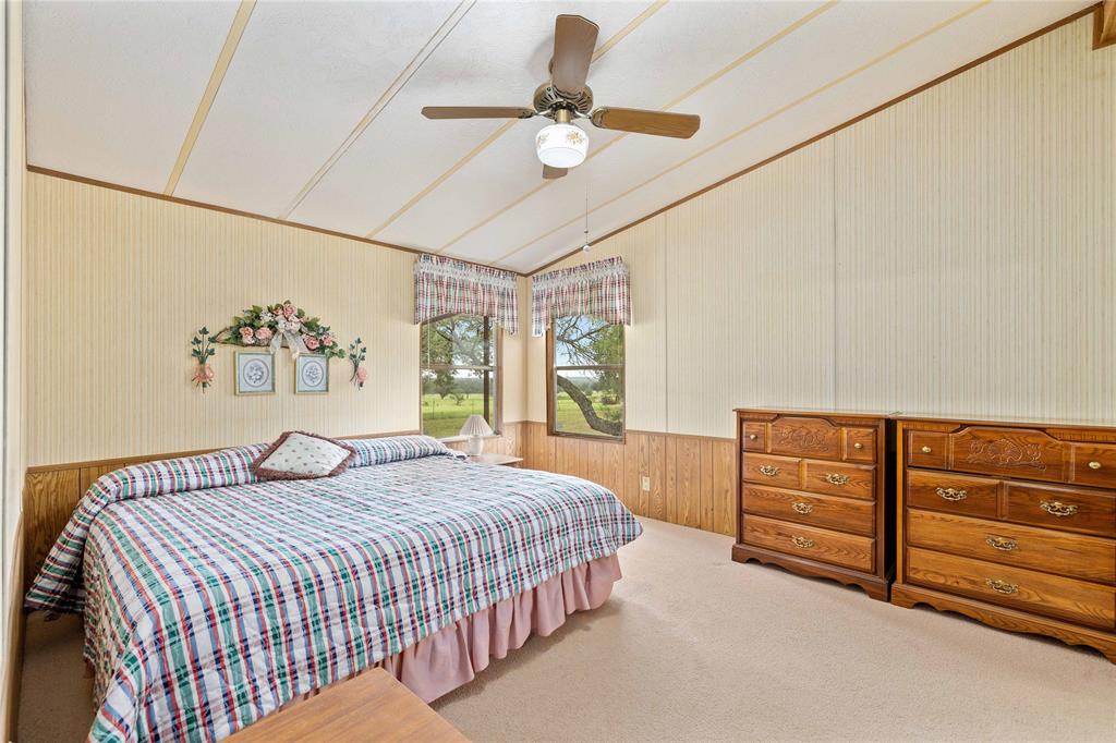 11814 County Road 266 Rochelle, TX 76872 - Photo 29 of 40 a bedroom with a bed and a chandelier