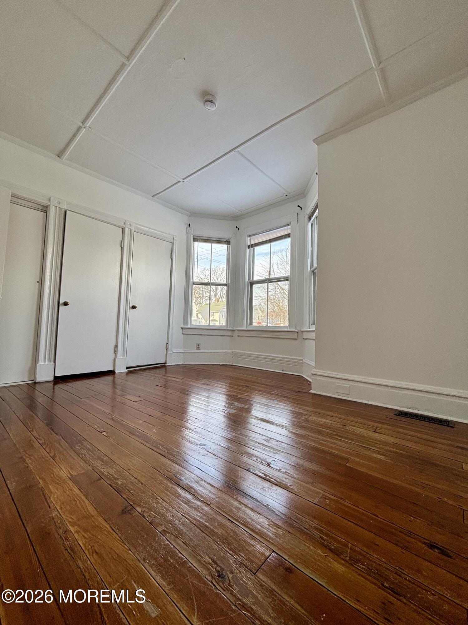 159 Bridge Avenue, Unit 1 Red Bank, NJ 07701 - Photo 11 of 22 an empty room with wooden floor and windows