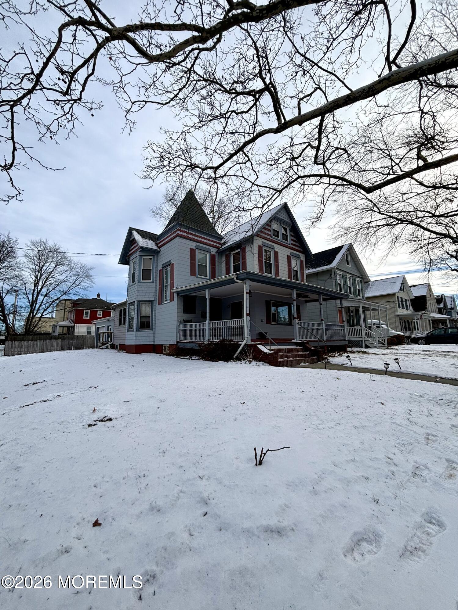 159 Bridge Avenue, Unit 1 Red Bank, NJ 07701 - Photo 17 of 22 a front view of a house with a yard covered in snow