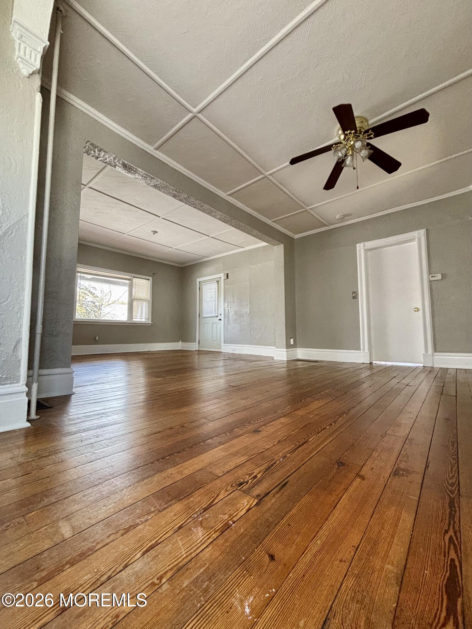 159 Bridge Avenue, Unit 1 Red Bank, NJ 07701 - Photo 18 of 22 a view of empty room with wooden floor and fan