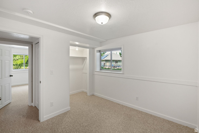 435 Canyon Road Millville, UT 84326 - Photo 43 of 113 Carpeted room featuring white walls, a single window, a built-in closet with hanging rod, and ceiling-mounted lighting