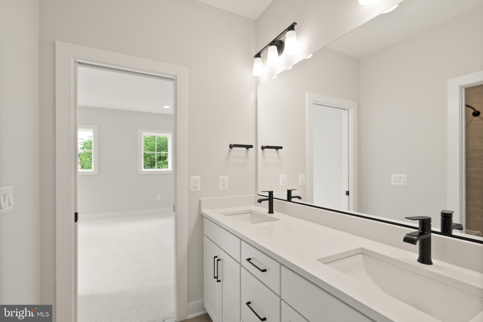 7204 Andrus Road Bethesda, MD 20817 - Photo 13 of 16 Sleek modern bathroom with natural light.