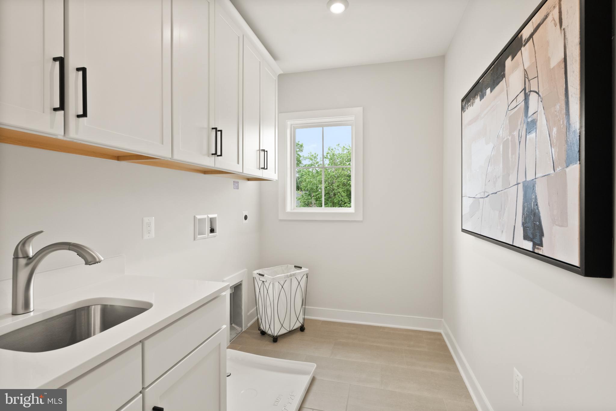 7204 Andrus Road Bethesda, MD 20817 - Photo 14 of 16 Bright and airy laundry space with modern design.