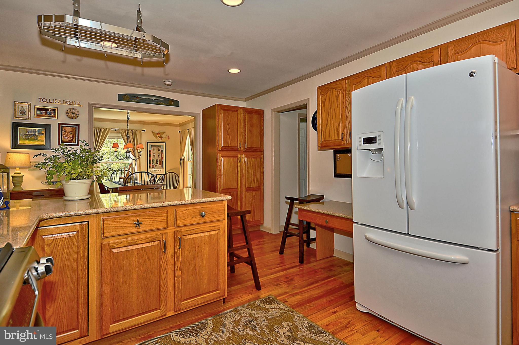 24100 Forest Pond Road St. Michaels, MD 21663 - Photo 13 of 20 a kitchen with stainless steel appliances a refrigerator and microwave