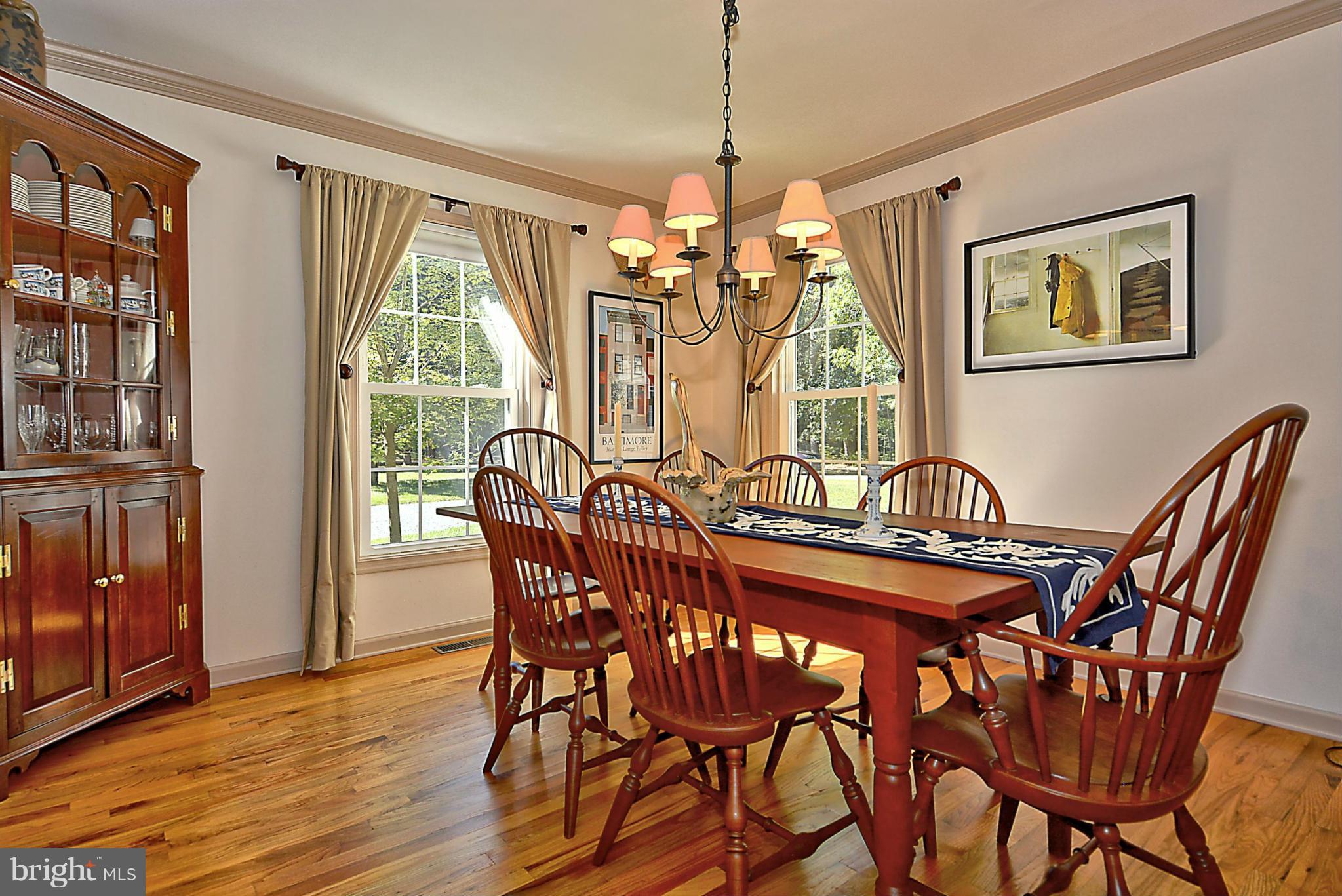 24100 Forest Pond Road St. Michaels, MD 21663 - Photo 7 of 20 a view of a dining room with furniture window and wooden floor