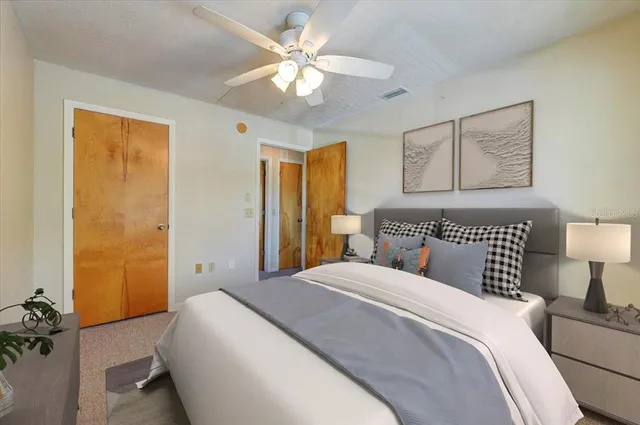 a bedroom with a bed and a chandelier